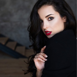 Cropped image of author Drusilla Black wearing black and red lipstick.