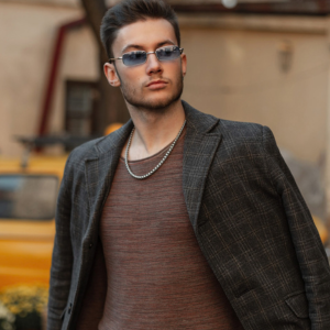 Cropped image of author Stone Green who is wearing casual attirehandsome model man hipster with elegant stylish clothes with sunglasses, trendy coat and sweatshirt walks in the city